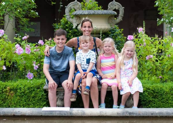 Laura with her children Lewis, 13, Harrison, three, Eva, five and Megan, four
