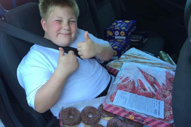 Sam Nelson delivered three boxes of doughnuts to police officers