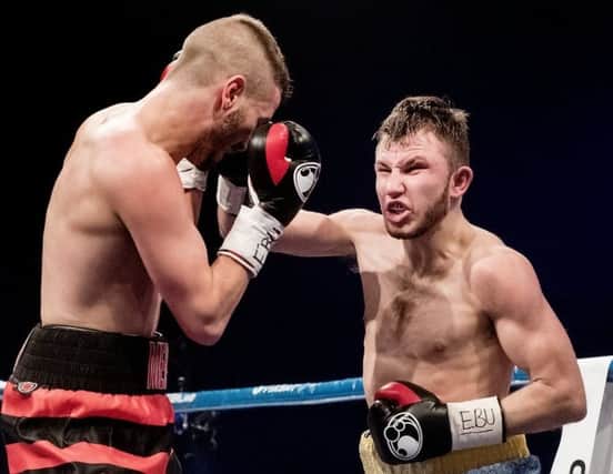 Isaac Lowe goes on the attack against Dennis Ceylan in their clash for the European featherweight title.