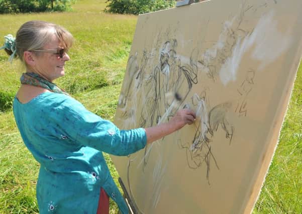 Artist Olivia Keith paints the scene at the scything course at Bell Sykes Farm.