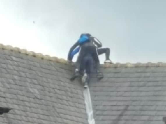 Children were recently pictured on top of a school roof