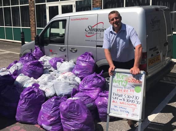 Gavin Preston is collecting unwanted clothes from members of his slimming group to raise funds for Cancer Research UK