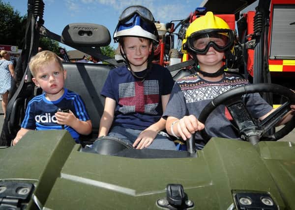 Preston Fire Station hosted an emergency services open day.
Regan Clitheroe, Ben Cartwright and Finlay Clitheroe aboard a off-road fire support vehicle.  PIC BY ROB LOCK
18-6-2017