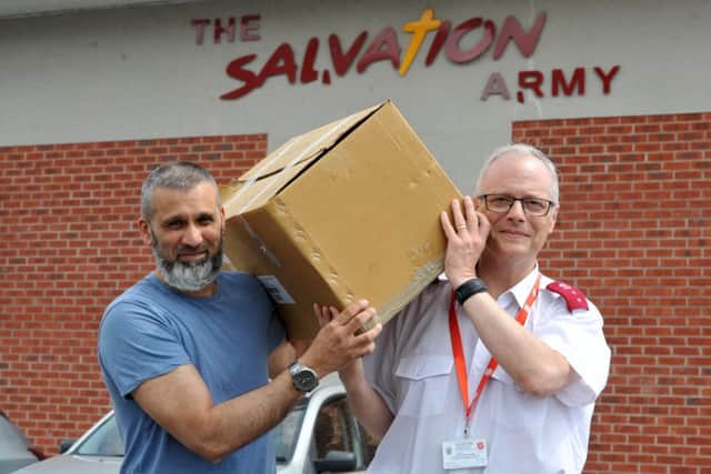 Alex Cadogan with Ilyas Esmail of the Muslim community in Preston delivering goods to the depleted Salvation Army food bank