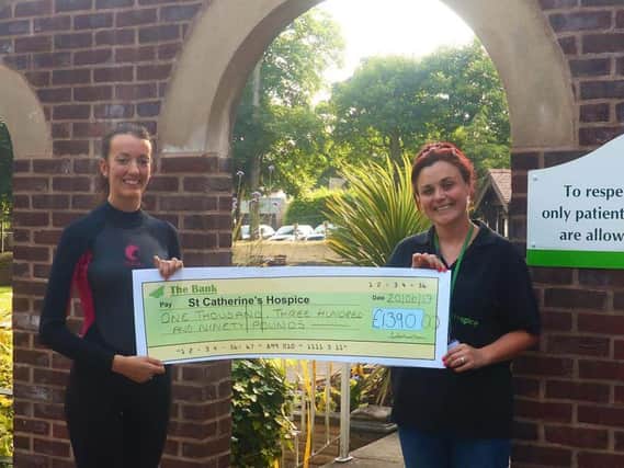 Lyndsey French, of Bamber Bridge, presents a cheque for 1,390 to Emma Jacovelli at St Catherine's Hospice