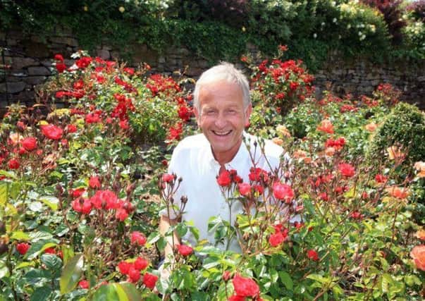 Raymond Smith in his bed of roses in the gardens of White Coppice Farm