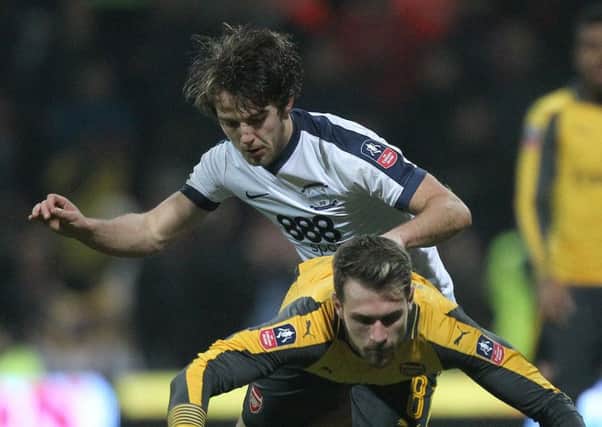 PNE midfielder Ben Pearson challenges Arsenal's Aaron Ramsey in the FA Cup clash at Deepdale