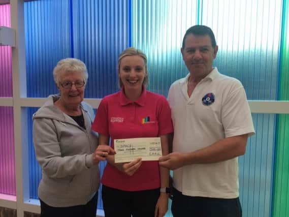 Garstang and Preston Motor Club treasurer, Margaret Duckworth and vice chairman Dave Nolan present a cheque for 300 to Jayne Billington at The Space Centre