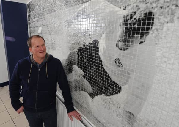 Simon Grayson at Deepdale in 2014 next to a tile mosaic of Sir Tom Finney