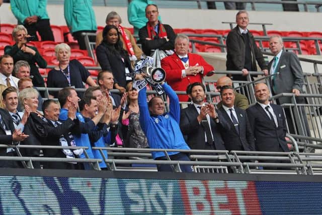 Simon Grayson lifts the League One play-off trophy at Wembley