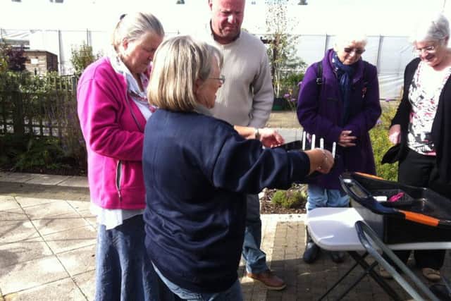 The Avant Gardening group taking part in a sweet pea planting demonstration