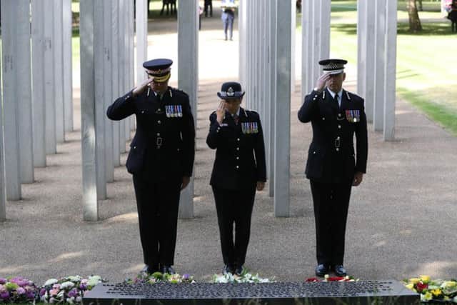 Metropolitan Police Commissioner Cressida Dick (centre) salutes after laying flowers during a service for the 12th anniversary of 7/7 attack.