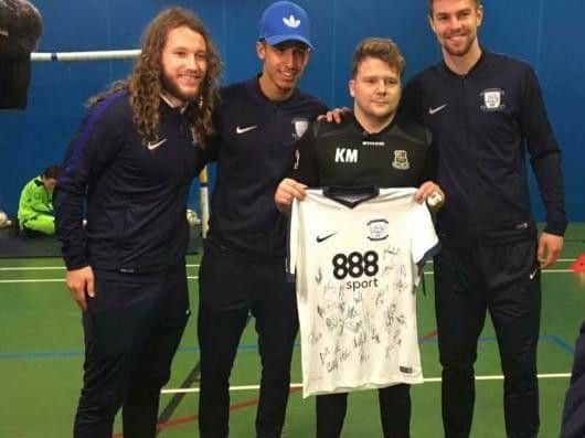 Kieran Miller, pictured holding a football shirt with Paul Huntington , Stevie May and Callum Robinson
