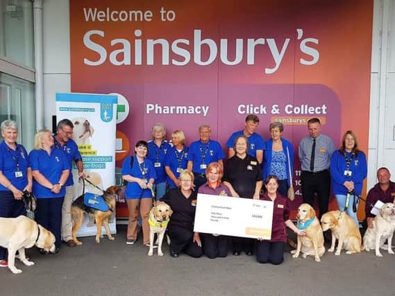 Team at Sainsbury's Bamber Bridge present 50,000 to Chorley Guide Dog volunteers