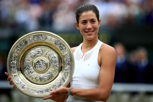 Garbine Muguruza with the trophy after beating Venus Williams