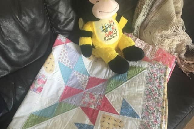 A bee teddy, and three blankets made by kind-hearted people across the world