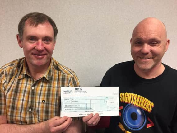 Peter Speight and Rick Moore with their cheque