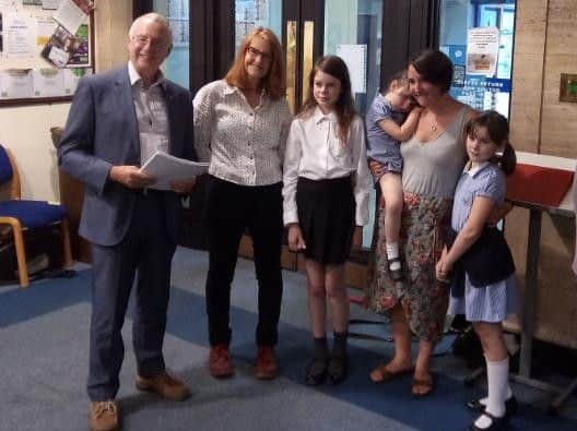 Council leader Peter Rankin receives the petition from Ben Ashworth's family