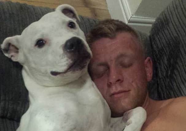 Billy Holmes with his dog Tyler who has been stolen during a burglary.
