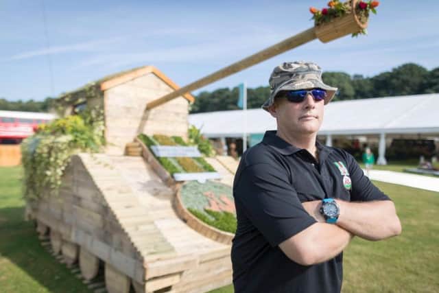 This garden hideaway has been transformed into a tank by the veterans of  Dig In North West using recycled pallets and cable drums. Pictured is veteran Chris Morley.
Picture by Mark Waugh / RHS