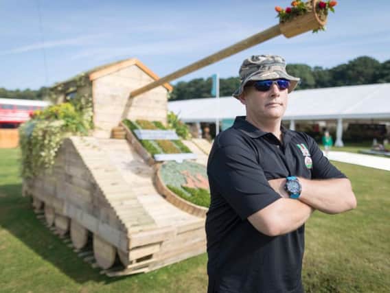 This garden hideaway has been transformed into a tank by the veterans of  Dig In North West using recycled pallets and cable drums. Pictured is veteran Chris Morley.
Picture by Mark Waugh / RHS