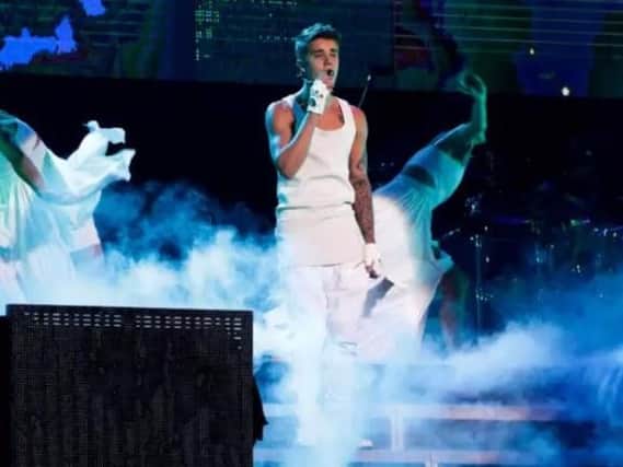 Justin Bieber performs on a stage during his world tour concert in Beijing