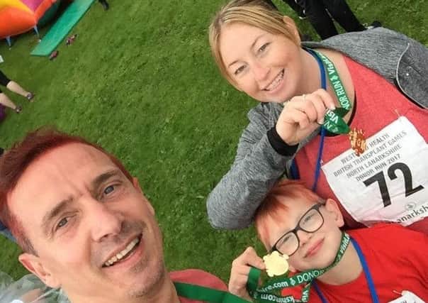 Harrison with his parents Michael and Melanie Roach at the games