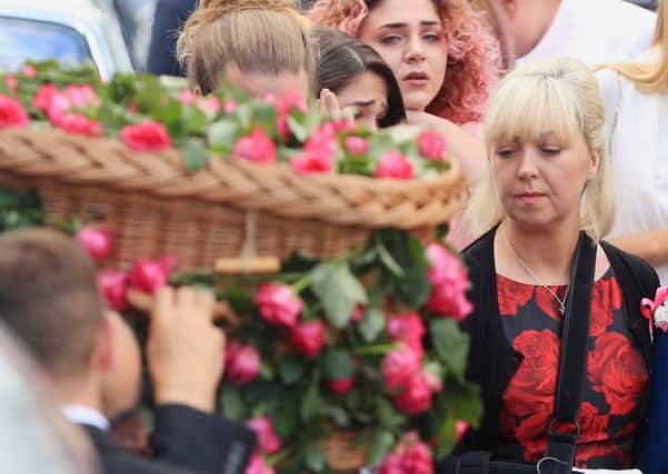 Mum Lisa Roussos looks on as the coffin of her daughter Saffie Roussos, who died in the Manchester Arena bombing, arrives at Manchester Cathedral for her funeral service.