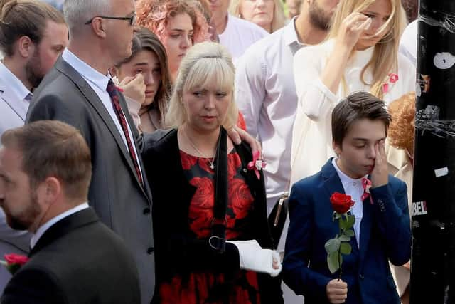 Mum Lisa Roussos and brother Xander arriving with mourners