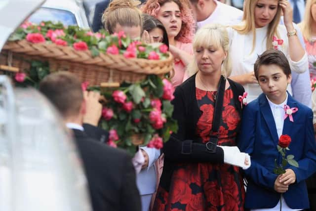 Mum Lisa Roussos and brother Xander look on as the coffin of Saffie Roussos, who died in the Manchester Arena bombing, arrives at Manchester Cathedral for her funeral service.