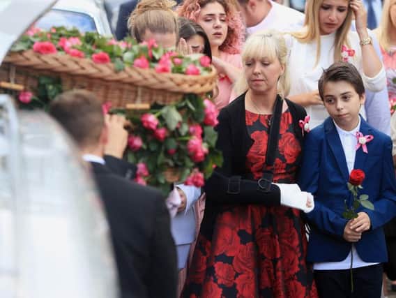 Mum Lisa Roussos and brother Xander look on as the coffin of Saffie Roussos, who died in the Manchester Arena bombing, arrives at Manchester Cathedral for her funeral service.