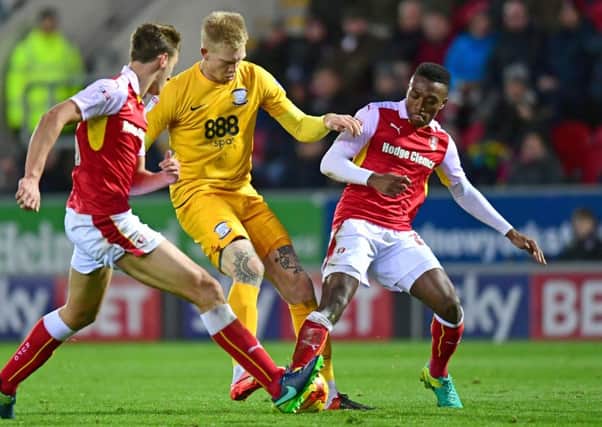 Darnell Fisher battles with Simon Makienok during PNE's visit to Rotherham last season.