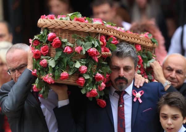 Andrew Roussos, 43, and  Xander hold the coffin of Saffie Roussos. Photo: Danny Lawson/PA Wire