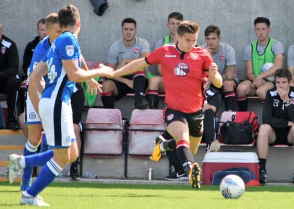 Aaron McGowan battles for the ball against Rochdale on Saturday.