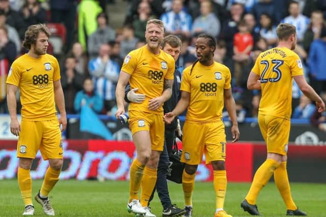 Preston North End's Tom Clarke leaves the field after rupturing his Achilles tendon at Huddersfield last season.