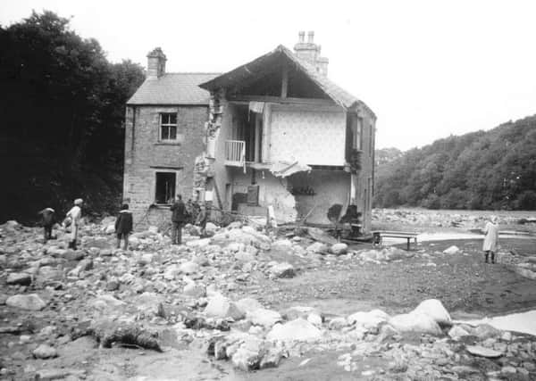 Backsbottom Farm, the home of Bill and Alice Brown and son Richard, was the first dwelling in the torrents way as it flowed down the narrow valley towards Wray village. Pictured here it is nothing but a ruined house amid a wilderness of rocks, tree trunks, mud and water.