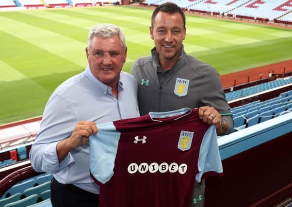 New Aston Villa signing John Terry with manager Steve Bruce during a press conference at Villa Park.