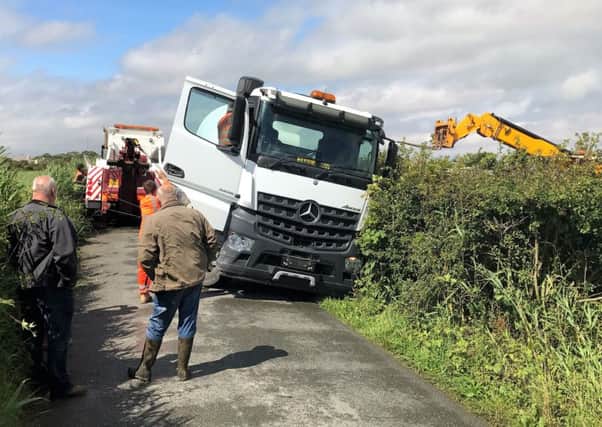 A cement mixer vehicle is recovered after becoming trapped by the side of the road on Carr Lane, Heysham. Photo by Event Photography by Hoggy.