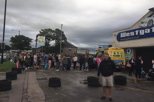 Graham Bailey from Westgate Tyres with the queue for the Mister Softee UK ice cream van behind him.