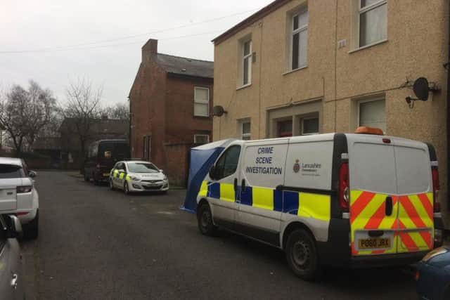 Police officers outside the scene of the murder