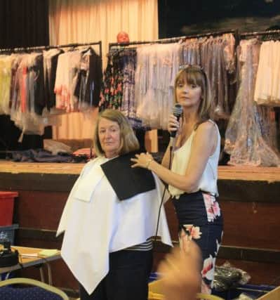 Sarah Harris from Colour Me Beautiful with a volunteer at Methodist Action (North West)'s Ladies Evening at St Martins Parish Hall, Fulwood