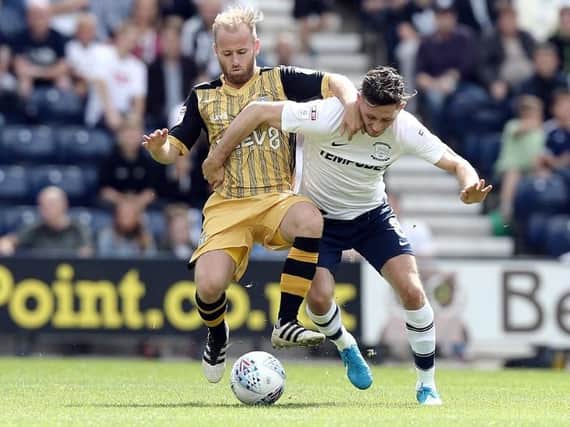 Alan Browne battles with Barry Bannan at Deepdale on Saturday.