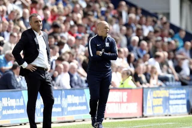 Alex Neil and Carlos Carvalhal on the touchline at Deepdale