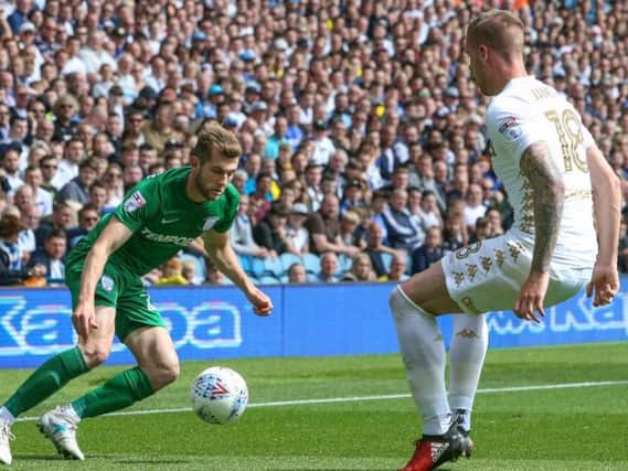 Tom Barkhuizen looks to take on Pontus Jansson at Elland Road.