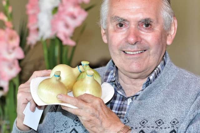 Picture by Julian Brown 12/08/17

Joe Gardner pictured with his onions

Cockerham Village Show