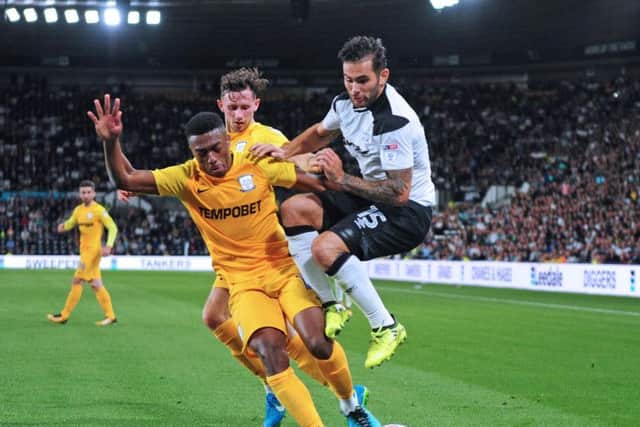 Darnell Fisher is challenged by Bradley Johnson