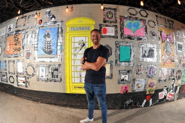 Landlord Andrew Forster with some of the urban art in his graffiti gallery at the Wellington Inn, Preston. Below: Banksy-style art on the walls.