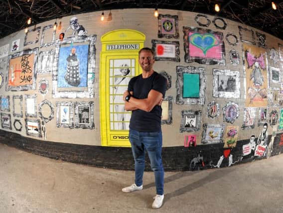 Landlord Andrew Forster with some of the urban art in his graffiti gallery at the Wellington Inn, Preston. Below: Banksy-style art on the walls.