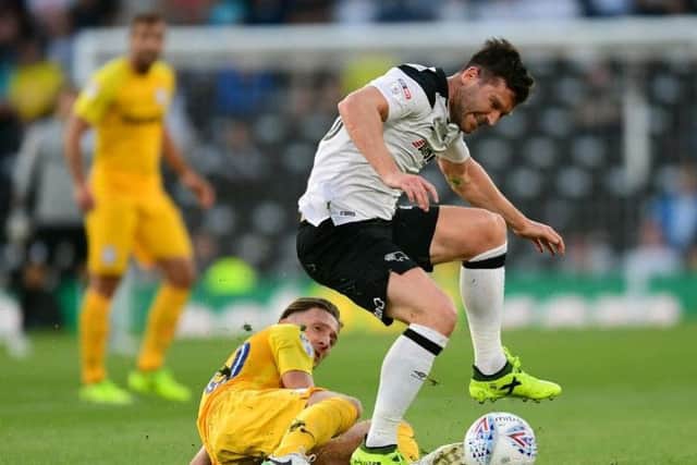 Ben Davies, who came in for Ben Pearson at Derby, battles with former PNE striker David Nugent.