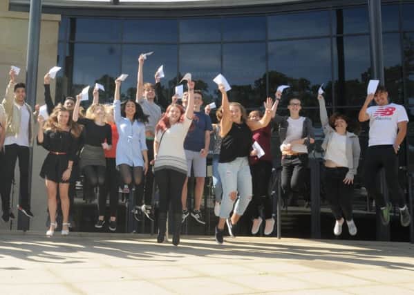 Students from Runshaw College, Leyland, open their results for A Level exams.